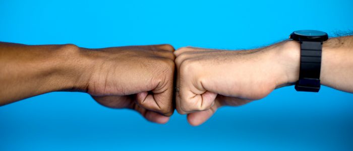 One set of knuckles meets another. Both are equal in this greeting that expresses approval and triumph.